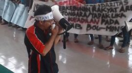 Seorang aktivis menyuarakan aspirasi petani dalam aksi demonstrasi menuntut keadilan atas konflik lahan perkebunan di Bolmong, Sulawesi Utara.